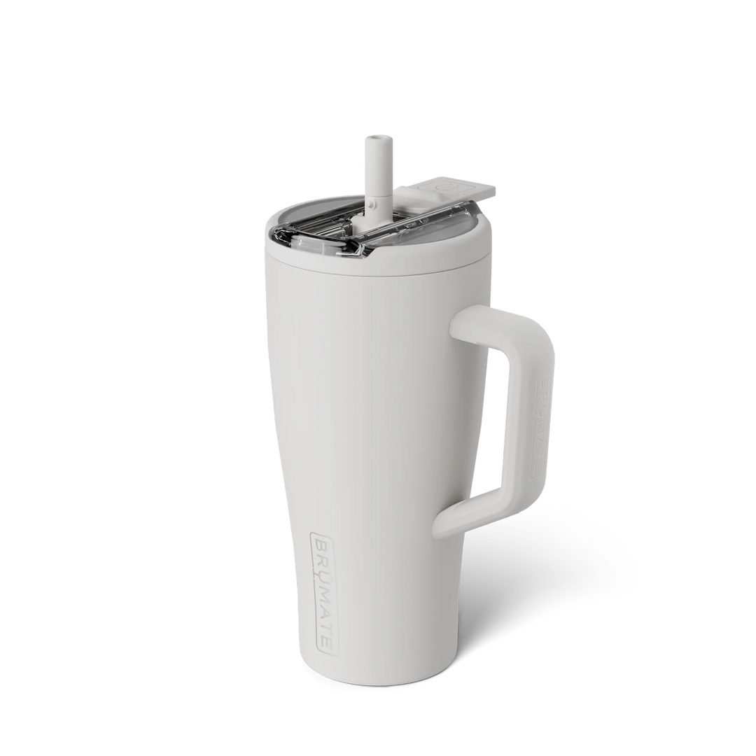 Studio product photograph by BrüMate of a white insulated tumbler featuring a clear spill-proof lid with a straw and a large ergonomic handle with an embossed logo