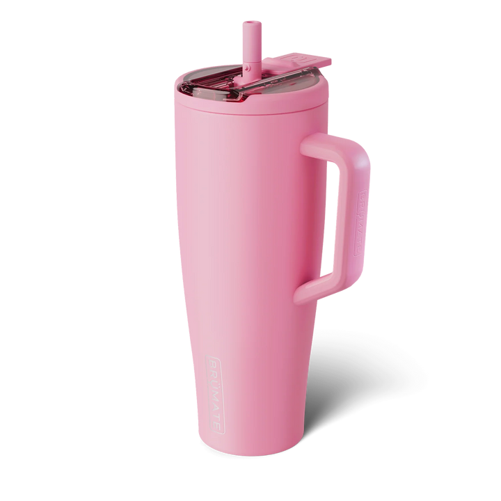 Product photograph of a BrüMate Era tumbler against a neutral background featuring a vibrant matte pink finish, a translucent lid with a matching straw, and a large side handle with the brand&