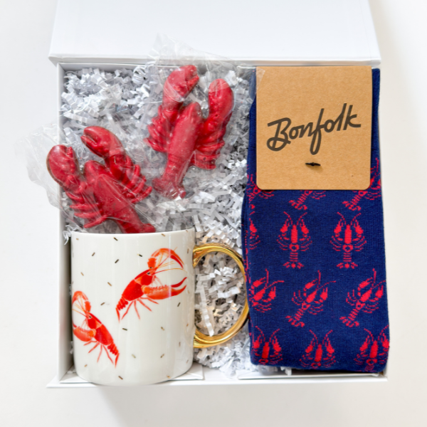 Gift set with mug, socks, and decorative items in a box