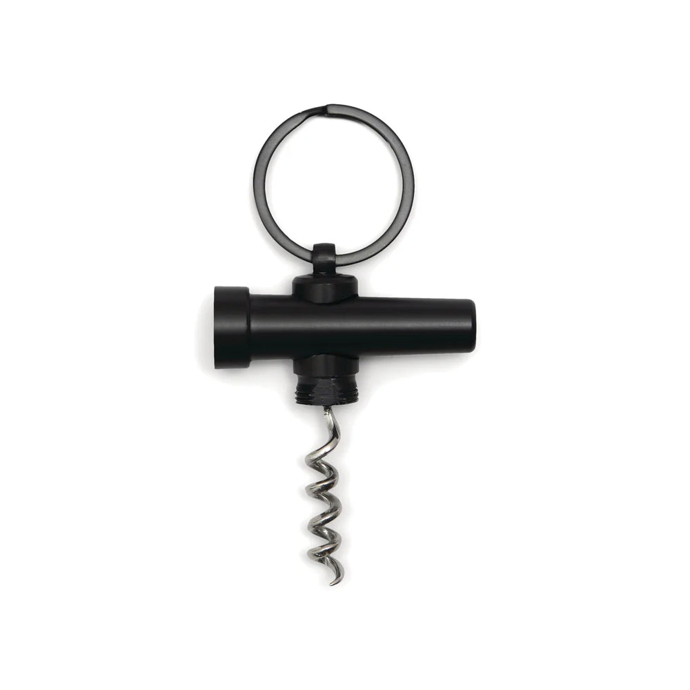 Studio product photograph of a matte black keychain corkscrew featuring a silver spiral worm and a circular split ring against a white background