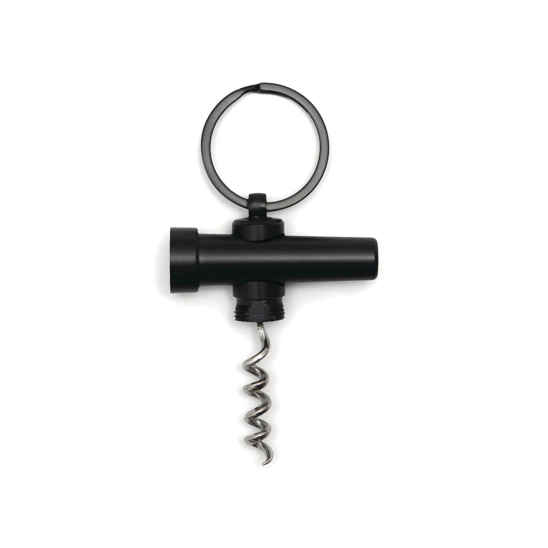 Studio product photograph of a matte black keychain corkscrew featuring a silver spiral worm and a circular split ring against a white background