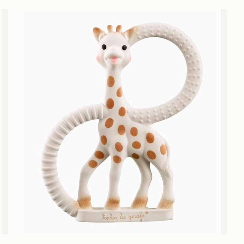 Natural rubber teether by Vulli featuring Sophie la girafe against a white background with brown spots and two circular handles with ribbed and bumpy textures for sensory relief