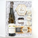 Gift set with a bottle of wine, cheese, and other items in a decorative box.