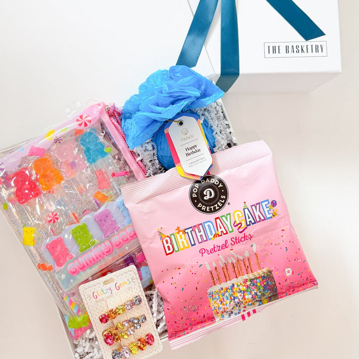 Packaged items with a blue bow on a white surface