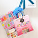Packaged items with a blue bow on a white surface
