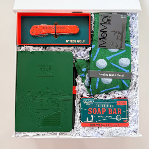 Grooming kit with green book, red tool, and soap bar in a box on a white background
