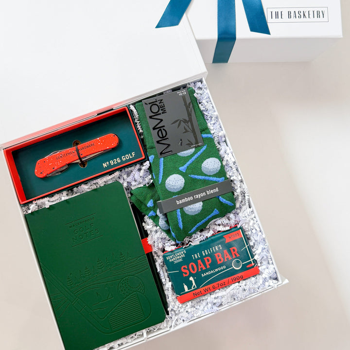 Gift set with stationery items and soap bar on a white surface