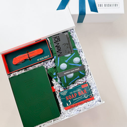 Gift set with stationery items and soap bar on a white surface