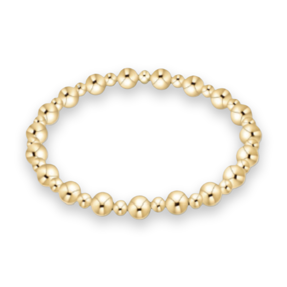 Gold jewelry beaded bracelet on a clean white background featuring alternating large and small polished yellow gold spheres with high-shine metallic reflections