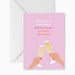Stationery greeting card featuring two hands with red nail polish toasting with champagne flutes against a pastel pink background with the playful text I like you more than brunch and I'm bou-jee so I really like brunch