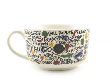 Ceramic bowl on a white background featuring a central GUMBO typography design alongside colorful hand-drawn illustrations of a blue crab, red chili peppers, and listed Cajun ingredients like roux and okra
