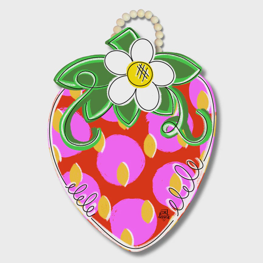 Digital illustration by DK designs of a decorative strawberry door hanger on a neutral background featuring a white blossom topper, vibrant pink polka dots, and yellow seed accents with a wooden bead loop
