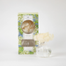 Commercial product photography by Greenleaf of a Hydrangea Flower Diffuser in a studio setting featuring a fluted clear glass vase, a cream sola wood flower, and a packaging box with detailed blue and white hydrangea illustrations
