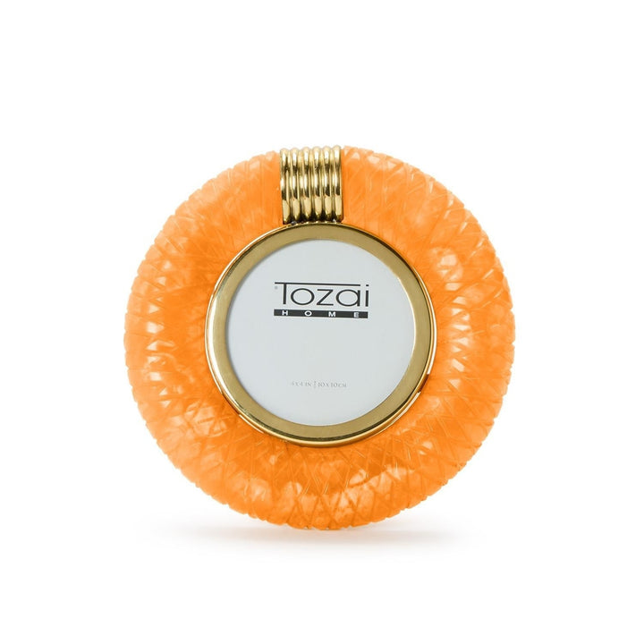 Hand-crafted resin by Tozai Home, this circular picture frame features a vibrant orange cross-hatch texture, a polished gold-tone inner rim, and a ribbed gold clip surrounding the Tozai Home logo against a white background