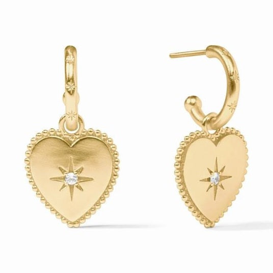 Gold jewelry heart-shaped charm hoop earrings on a white background featuring celestial star-set crystals, beaded milgrain edges, and delicate star engravings on the metal hoops