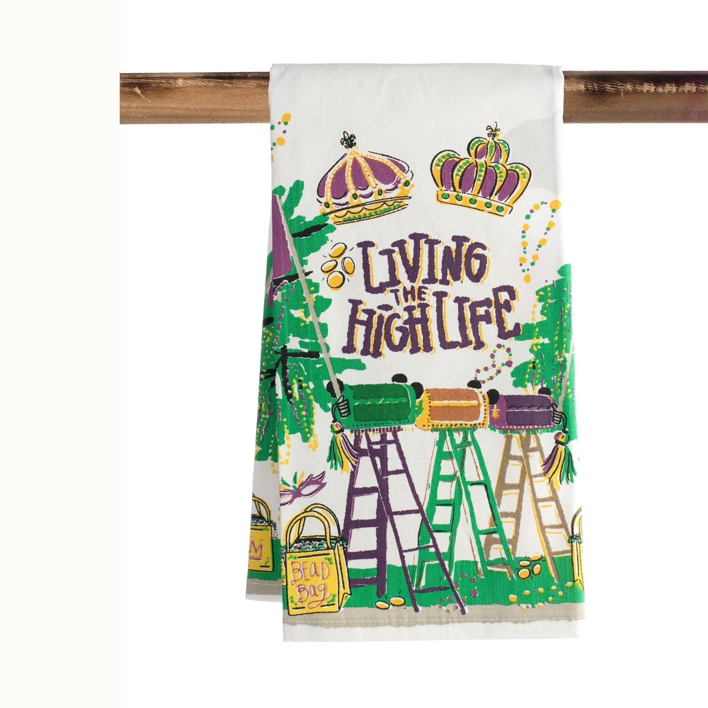 Illustrated tea towel depicting a New Orleans Mardi Gras celebration with iconic parade ladders and royal crowns above the text Living the High Life alongside a yellow bead bag and vibrant purple green and gold beads