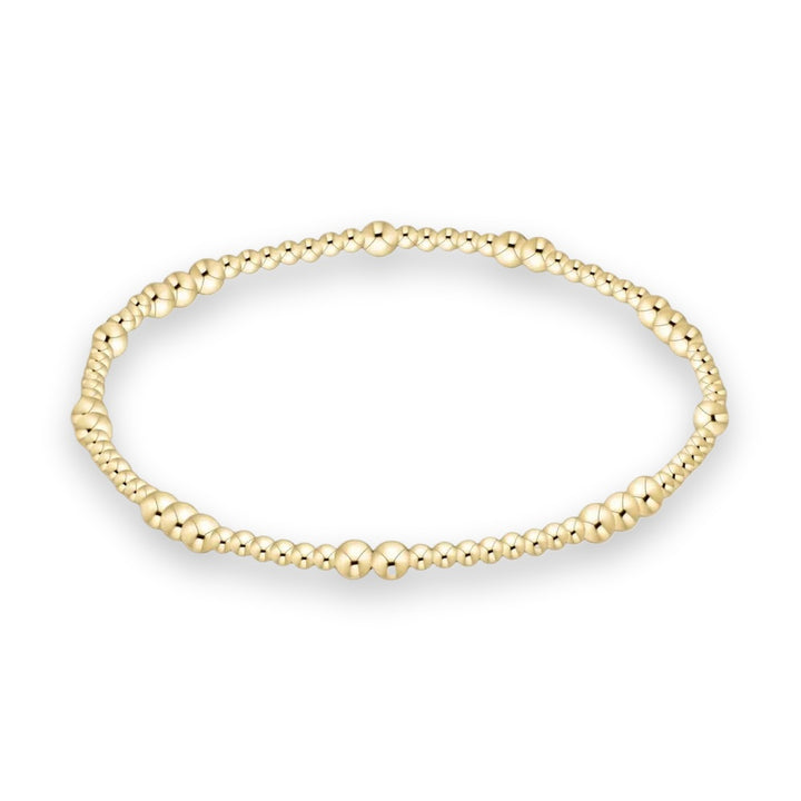 Yellow gold beaded bracelet featuring graduated spherical beads with a high-polish reflective finish centered on a minimalist white background