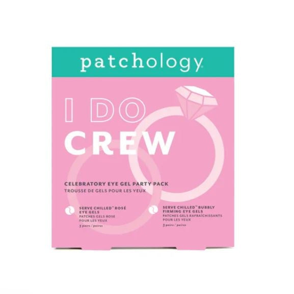 Graphic design by Patchology of the I DO CREW celebratory eye gel party pack featuring a vibrant pink background, teal top banner, and white interlocking wedding rings with a large faceted diamond illustration
