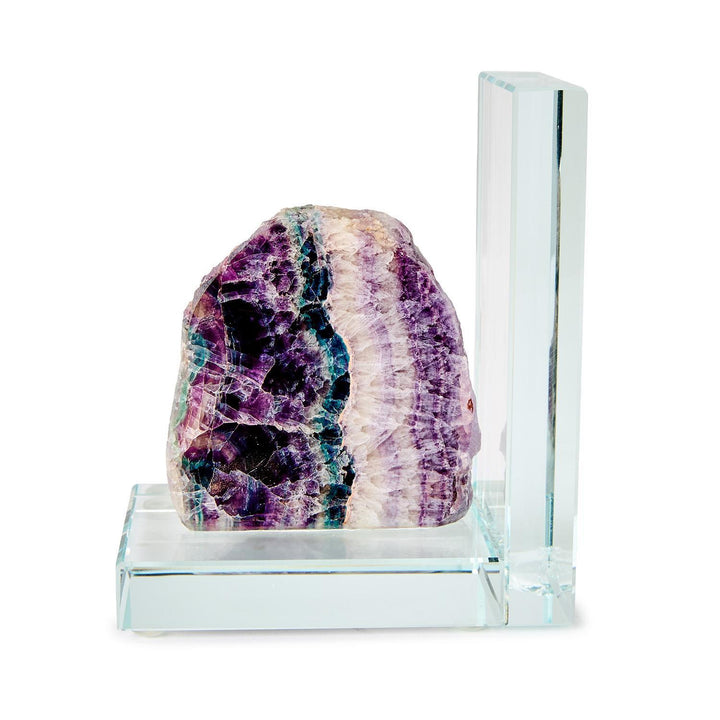 Natural fluorite crystal bookend mounted on a clear glass base featuring vibrant purple and teal banding with a jagged crystalline texture against a white studio background