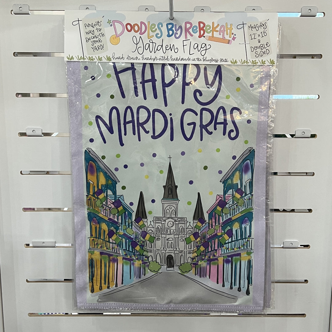 Hand-drawn garden flag by Doodles by Rebekah depicting a Happy Mardi Gras celebration in New Orleans featuring the St. Louis Cathedral, festive balconies with purple flags, and colorful confetti dots