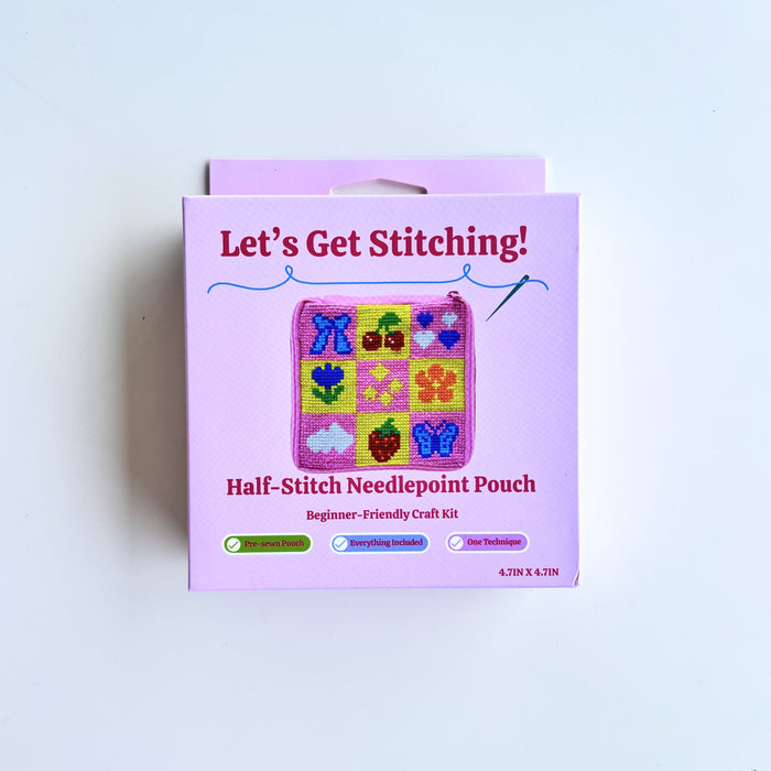 A pink retail box for a 'Let's Get Stitching! Half-Stitch Needlepoint Pouch' craft kit, photographed against a plain white background.
