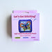 A boxed craft kit labeled "Let's Get Stitching!" and "Half-Stitch Needlepoint Pouch" on a plain white background. The package is light purple/lilac with a butterfly needlepoint example shown on the front.