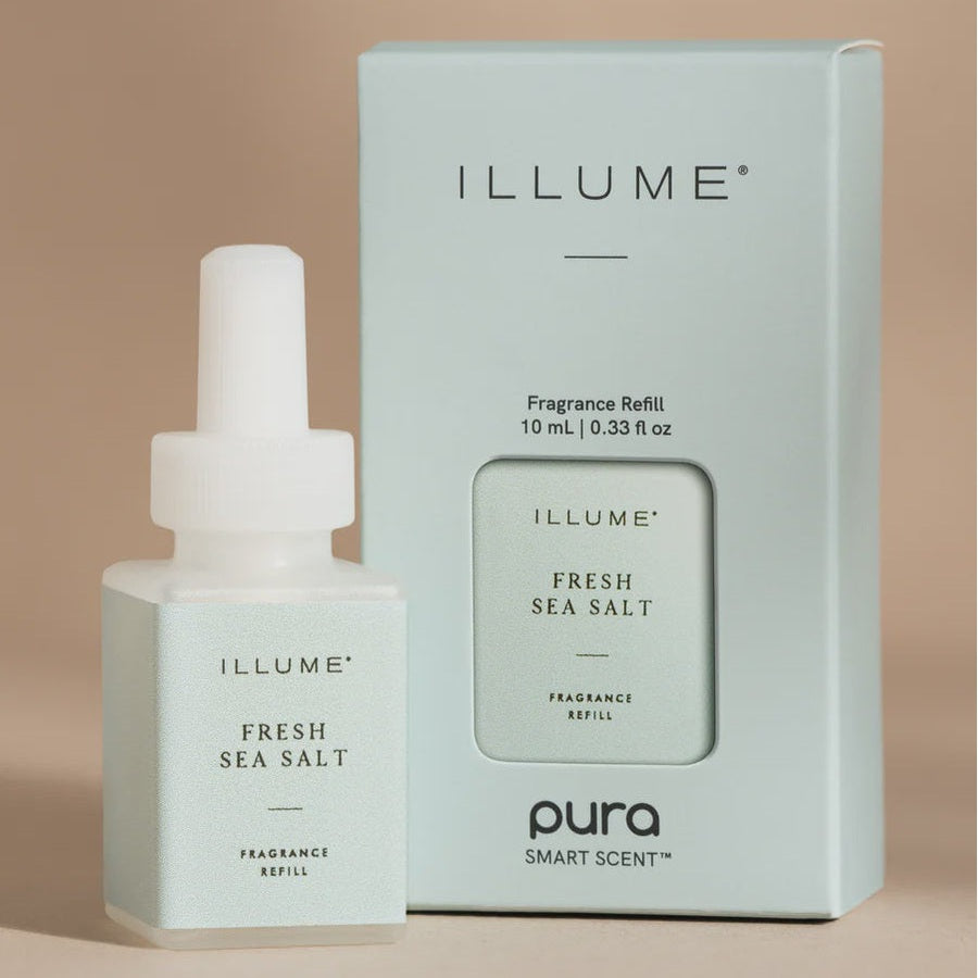 Studio photograph of Illume Fresh Sea Salt fragrance refill for Pura Smart Scent showcasing a pale mint green bottle and box with a white dropper cap and minimalist black typography