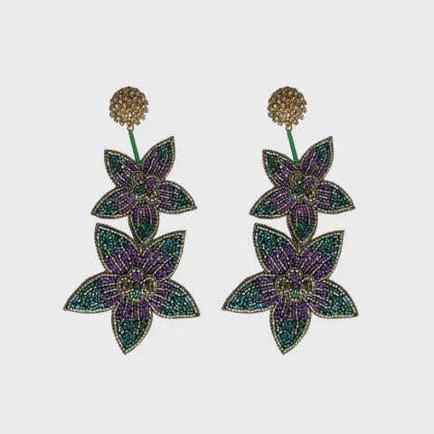 Pair of beaded dangle earrings with two purple and green flowers below a gold beaded post