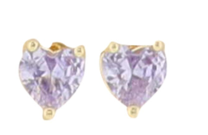 Gold and amethyst jewelry featuring a pair of heart-shaped stud earrings with faceted lavender gemstones and minimalist three-prong settings against a clean white background