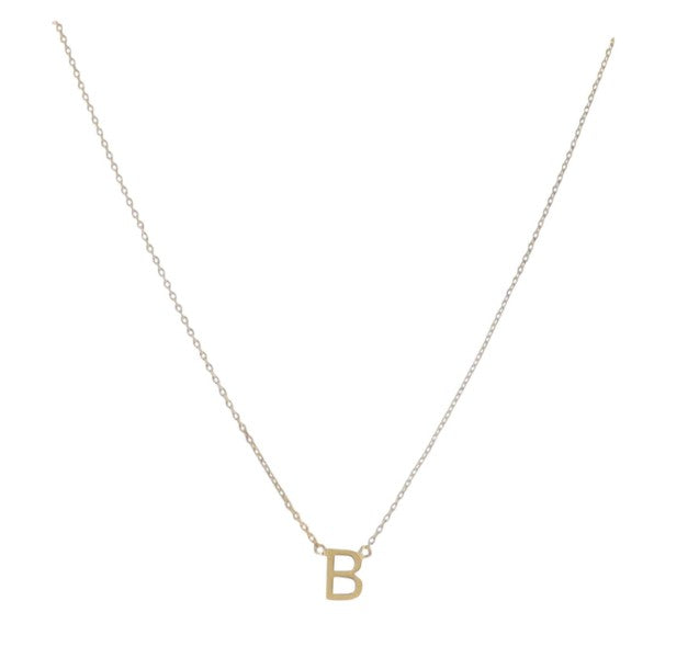 Gold jewelry necklace featuring a polished sans-serif letter B pendant suspended from a delicate cable chain against a minimalist white background