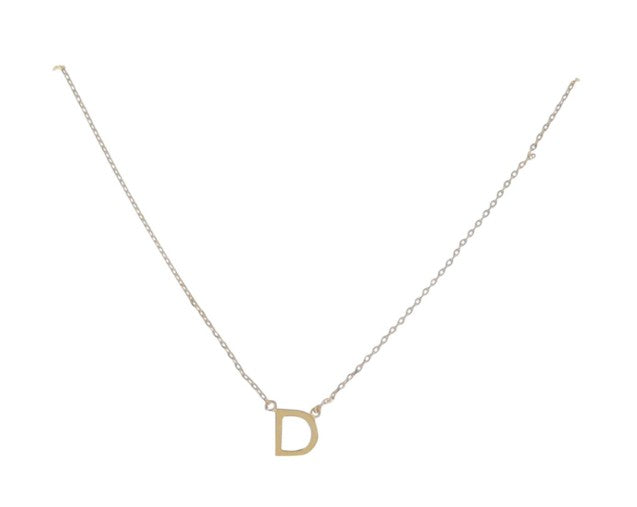 Gold necklace featuring a polished capital letter D initial pendant centered on a delicate cable chain with small circular jump rings and a reflective metallic surface set against a white background