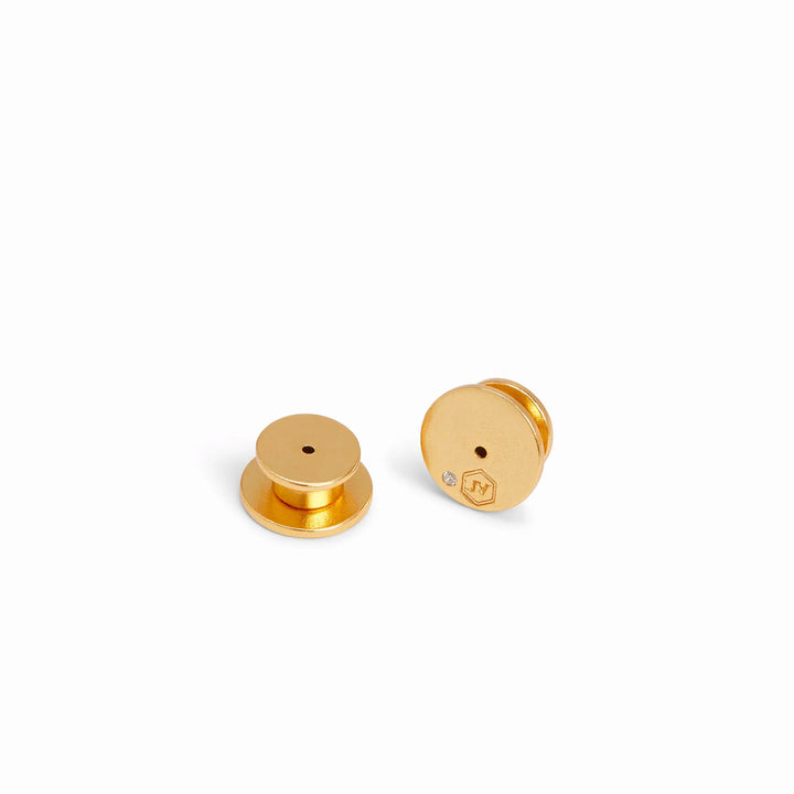 Gold-toned metal pin backs by Jenifer Yellow positioned on a white background featuring a small inset clear gemstone and an engraved JY brand logo within a hexagon
