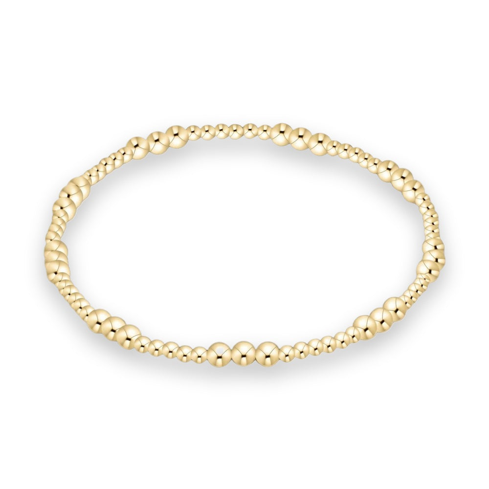 Polished yellow gold beaded bracelet featuring graduated sphere sizes and a high-shine reflective finish set against a clean white background