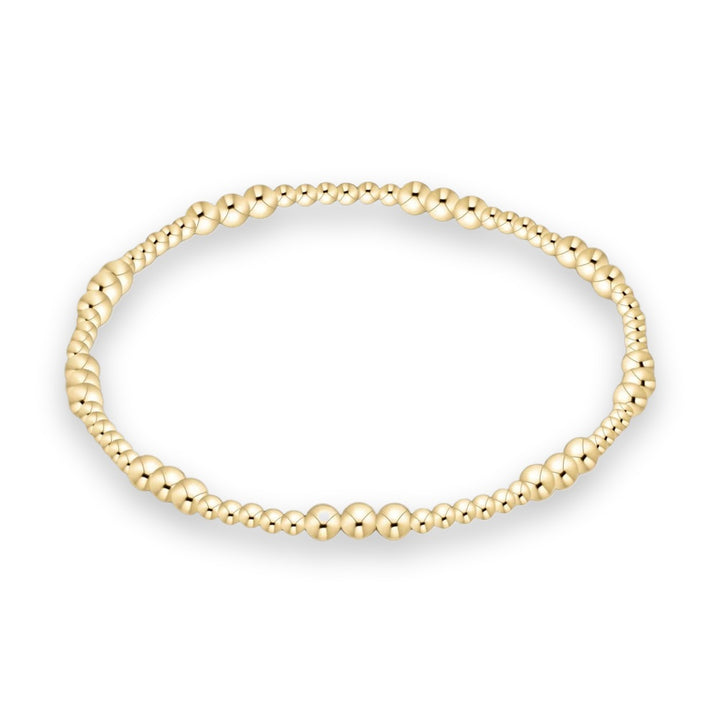 Polished yellow gold beaded bracelet featuring graduated sphere sizes and a high-shine reflective finish set against a clean white background