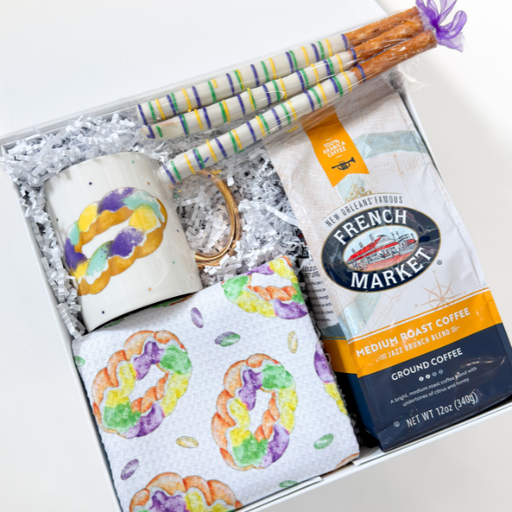 Gift set with mug, napkins, coffee, and pretzel-themed items in a box.