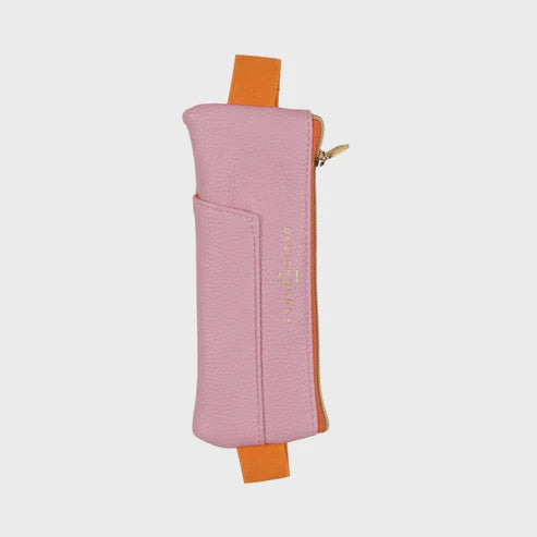Pebbled leather pouch by Draper James featuring a pink pencil case centered on a neutral background with vibrant orange elastic straps, the gold-stamped Draper James logo, and a gold-tone zipper pull