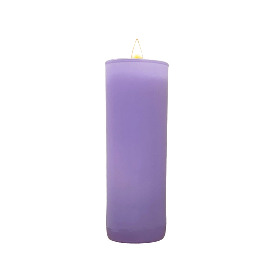 Lit lavender votive candle on a white background