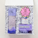 Set of hair care products including a bottle, a jar, and a brush in a decorative box on a white background.