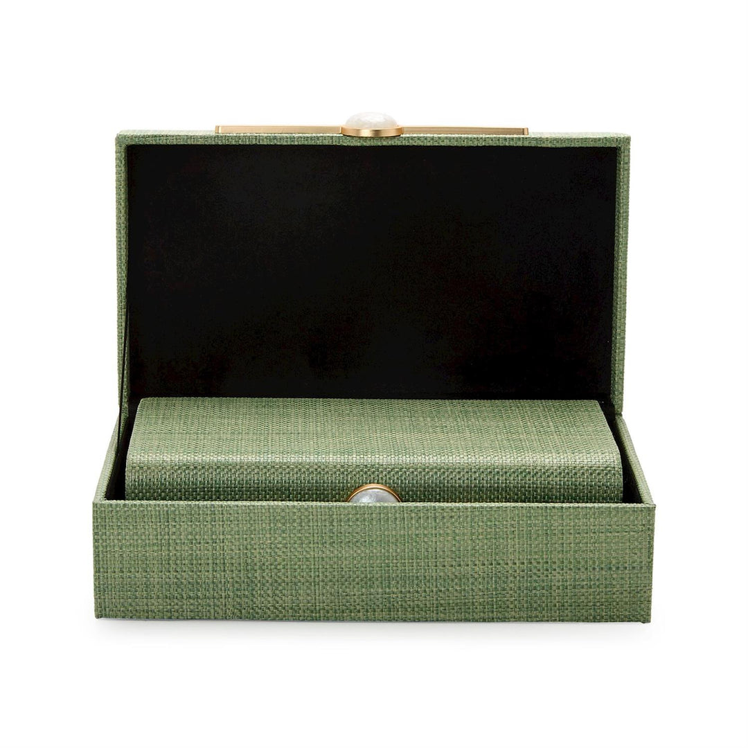 Studio photograph of an open sage green woven raffia clutch bag on a white background featuring a black interior lining, a nested smaller rectangular case, and a white pearlized bead clasp on a horizontal gold bar