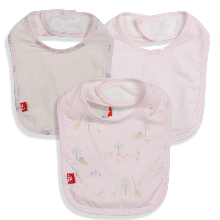 Cotton Mothercare brand baby bibs in soft pink featuring a whimsical safari animal print with giraffes and lions, hook-and-loop neck closures, and small red logo tags on a white background