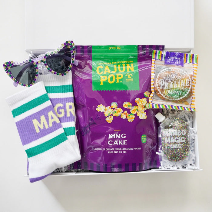 Packaged snacks with a purple bag labeled 'Ming Cake' and a white bag with green stripes, on a white background.