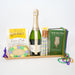 Bottle of champagne on a tray with Mardi Gras-themed items including beads and books.