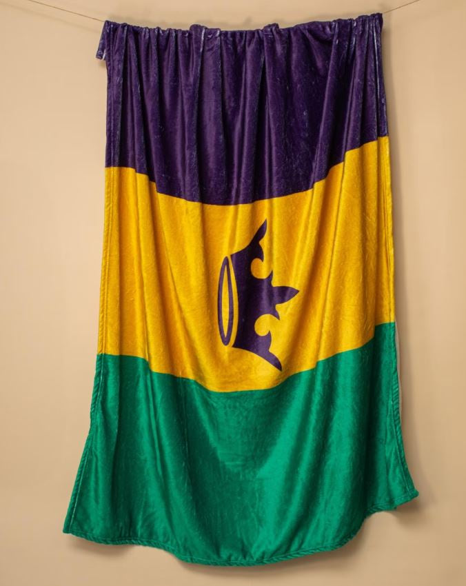 Throw blanket in purple, gold and green stripes with a purple crown in the center