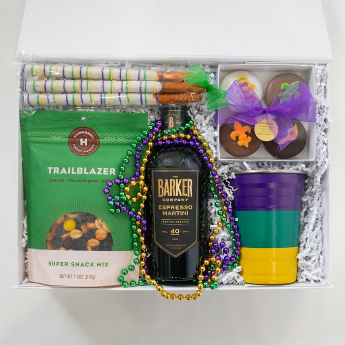 Gift basket with a bottle of Barker whiskey, snacks, and decorative items on a white background