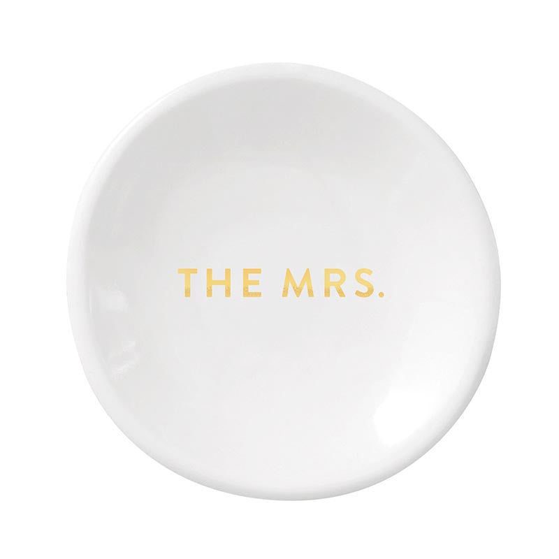 Ceramic trinket dish featuring gold-foiled all-caps lettering that reads THE MRS. centered on a glossy white circular surface