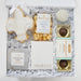 Gift box with cookies, chocolate, and other treats on a white background