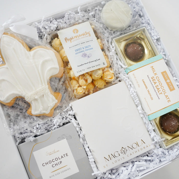 Gift box with cookies, popcorn, and chocolate truffles on a white background