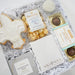 Gift box with cookies, popcorn, and chocolate truffles on a white background