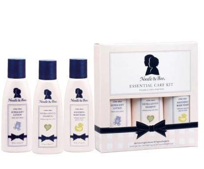 Product photograph by Noodle &amp; Boo of an Essential Care Kit on a white background featuring the signature profile silhouette logo and navy blue caps along with colorful icons of a blue teddy bear a green heart and a yellow rubber ducky