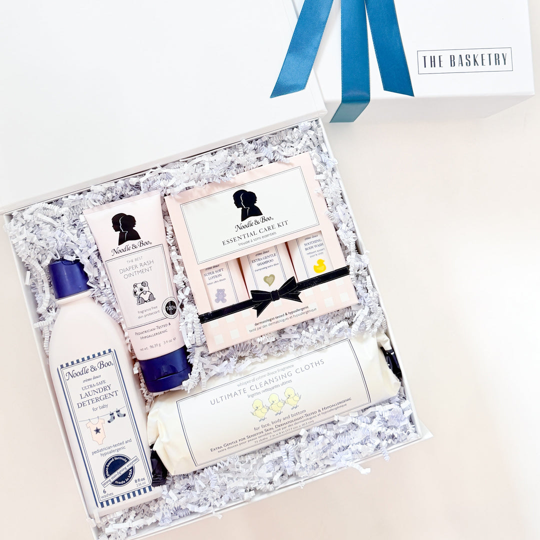 Gift set with skincare products and a blue ribbon on a white background